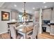 Eat-in kitchen with light cabinets, granite counters, and breakfast table at 2222 E 75Th St, Indianapolis, IN 46240