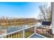 Deck overlooking peaceful river, lush trees, and a quaint boathouse at 2222 E 75Th St, Indianapolis, IN 46240