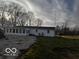 Rear view of a ranch house with a sunroom and a large backyard at 5233 S Vine St, Columbus, IN 47201