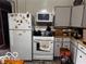 Kitchen with white appliances and cabinets at 5233 S Vine St, Columbus, IN 47201