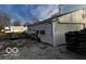 White storage shed with a side door and wood pile at 5233 S Vine St, Columbus, IN 47201