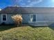 Small backyard with grass, deck, and tall grass at 7254 Broyles Ln, Indianapolis, IN 46217
