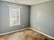 Simple bedroom with gray walls, tile floor, and window at 7254 Broyles Ln, Indianapolis, IN 46217