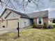 Brick and vinyl ranch home with 2-car garage and landscaped yard at 7254 Broyles Ln, Indianapolis, IN 46217