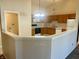 Kitchen with oak cabinets, white appliances, and breakfast bar at 7254 Broyles Ln, Indianapolis, IN 46217