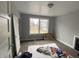 Bright bedroom with gray walls, carpet, and a window overlooking the backyard at 1048 N Mount St, Indianapolis, IN 46222