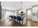 Modern kitchen with white cabinets, a large island, and blue bar stools at 107 Woodview Dr, Pittsboro, IN 46167