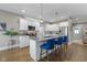 Modern kitchen with white cabinets, a large island, and blue bar stools at 107 Woodview Dr, Pittsboro, IN 46167