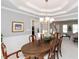 Elegant dining room with chandelier and chair rail at 12540 Sandstone Run, Carmel, IN 46033