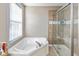 Bathroom features a corner tub and a large walk in shower at 12551 Brookhaven Dr, Fishers, IN 46037