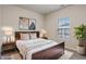 Bright bedroom with double bed, nightstands, and window at 12914 University Cres # 3C, Carmel, IN 46032