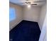 Small bedroom with dark blue carpet and ceiling fan at 1510 E Gimber St, Indianapolis, IN 46203
