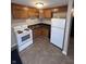 Galley kitchen with wood cabinets and white appliances at 1510 E Gimber St, Indianapolis, IN 46203