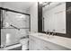 Updated bathroom with a walk-in shower, white vanity, and modern fixtures at 5835 Victory Ave, Indianapolis, IN 46203