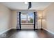 Bright bedroom featuring dark hardwood floors, large window, and ceiling fan at 5835 Victory Ave, Indianapolis, IN 46203