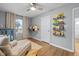 Bedroom with hardwood floors and built-in shelves at 6146 Evanston Ave, Indianapolis, IN 46220