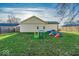 Backyard with grassy area, wooden fence, and playset at 637 Holiday Dr, Fortville, IN 46040