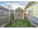 Tan colored storage shed in backyard next to wooden fence at 637 Holiday Dr, Fortville, IN 46040