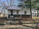 Cute ranch home with a covered porch and a well-maintained lawn at 715 N Warman Ave, Indianapolis, IN 46222