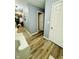 Gray hallway with wood-look flooring and white doors at 8045 Retreat Ln, Indianapolis, IN 46259