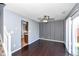 Dining area with hardwood floors, black and white striped wall, and sliding door to patio at 9122 Bagley Dr, Indianapolis, IN 46231