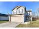 Two-story house with gray siding, attached garage, and a well-maintained lawn at 9122 Bagley Dr, Indianapolis, IN 46231