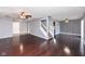 Spacious living area with hardwood floors, staircase, and ceiling fan at 9122 Bagley Dr, Indianapolis, IN 46231