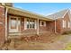 Brick front porch with a wooden door and windows at 995 E 256Th St, Sheridan, IN 46069