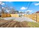 Large backyard with gravel area and wooden fence at 1101 W Roache St, Indianapolis, IN 46208
