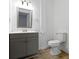 Simple bathroom with gray vanity, mirror, and vinyl flooring at 1101 W Roache St, Indianapolis, IN 46208