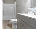 Clean bathroom featuring gray vanity, shower/tub combo, and vinyl flooring at 1101 W Roache St, Indianapolis, IN 46208