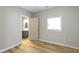 Bedroom with light gray walls, wood-look flooring and access to bathroom at 1101 W Roache St, Indianapolis, IN 46208