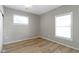 Bright bedroom with neutral walls, vinyl flooring, and two windows at 1101 W Roache St, Indianapolis, IN 46208