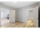 Bedroom with light gray walls, wood-look flooring, and access to bathroom at 1101 W Roache St, Indianapolis, IN 46208