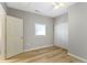 Bedroom with light gray walls, wood-look flooring, and double closet at 1101 W Roache St, Indianapolis, IN 46208