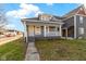 Updated bungalow exterior, featuring gray siding and a front yard at 1101 W Roache St, Indianapolis, IN 46208