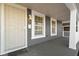 Inviting front porch with a gray exterior and security door at 1101 W Roache St, Indianapolis, IN 46208