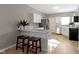 Modern kitchen with white cabinets, stainless steel appliances, and a breakfast bar at 1101 W Roache St, Indianapolis, IN 46208
