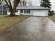 Gray house with a white garage door and mature tree at 1501 Ashley Dr, Lebanon, IN 46052