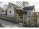 Tan house with wooden fence and small front yard at 1505 E Kelly St, Indianapolis, IN 46203