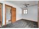 Bedroom with grey carpet, wood door, and ensuite bathroom at 1641 Manhattan Ave, Indianapolis, IN 46241