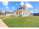 Beautiful two-story home with a yellow door and front porch at 2005 Columbia Ave, Indianapolis, IN 46202