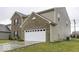 Side view of a two-story house showcasing a white garage door and a neat lawn at 2539 Shadowbrook Trce, Greenwood, IN 46143