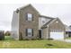 Two-story home with brick and siding accents, a white garage door, and a neat lawn at 2539 Shadowbrook Trce, Greenwood, IN 46143