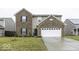 Two-story brick home with a large white garage door and well-manicured lawn at 2539 Shadowbrook Trce, Greenwood, IN 46143