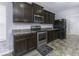 Modern kitchen with dark cabinets, stainless steel appliances and tile flooring at 2539 Shadowbrook Trce, Greenwood, IN 46143