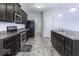 Modern kitchen with dark cabinets, stainless steel appliances and tile flooring at 2539 Shadowbrook Trce, Greenwood, IN 46143