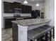 Modern kitchen with dark cabinets, stainless steel appliances, and an island with seating at 2539 Shadowbrook Trce, Greenwood, IN 46143