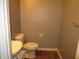 Small half bathroom with a toilet and sink at 317 N Bradley Ave, Indianapolis, IN 46201