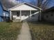 Charming white bungalow with a front porch and walkway at 317 N Bradley Ave, Indianapolis, IN 46201